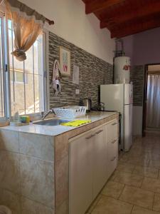 a kitchen with a sink and a refrigerator at CATALINA in Neuquén