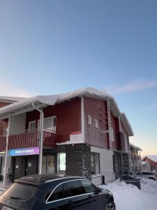 a car parked in front of a red building at Levistar311 in Sirkka