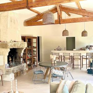 - un salon avec une table et une cheminée dans l'établissement maison aux Baux de Provence, aux Baux-de-Provence