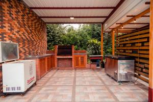an outdoor patio with a grill and a stove at Casa Campo Victoria in Valledupar