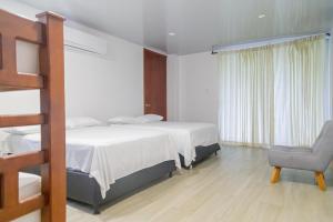 Habitación de hotel con cama y silla en Casa Campo Victoria, en Valledupar