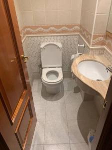 a bathroom with a toilet and a sink at Ca La Solé in Vinarós