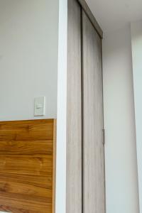 a pair of wooden doors in a room at Luxury Apartments estilo New York in Guayaquil