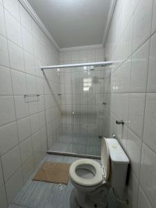 a bathroom with a shower and a toilet in it at Residencial Vilaça in Guarapari