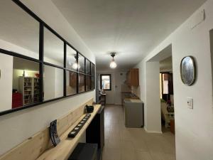 a living room with a long bench and a kitchen at Appartamento in the Heart of Tuscany in Monsummano