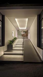 a hallway with stairs in a building at night at N&L APARTAMENT SUIT in La Falda
