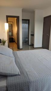 a large white bed in a room with a bedroom at N&L APARTAMENT SUIT in La Falda