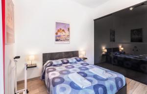 a bedroom with a large bed and a mirror at Waterfront District Apartment in Genova