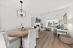a dining room and living room with a wooden table and chairs at 542 Tarpon Pond Cottage in Seabrook Island