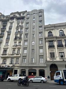 a large building with cars parked in front of it at Plaza San Martin Retiro in Buenos Aires
