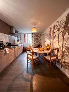 a kitchen with a table and chairs in a room at Givernel in Giverny +32 photos