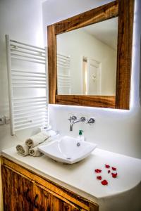 a bathroom with a sink and a mirror at La Skala - Apartment with great sea view in Essaouira
