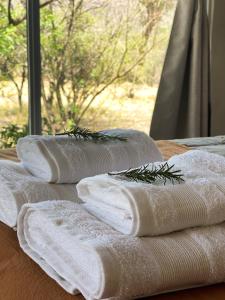four towels with plants on them sitting on a table at Las Quimeras in Nono