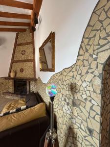 een woonkamer met een bank en een mozaïekmuur bij Villa Víctor in Cómpeta