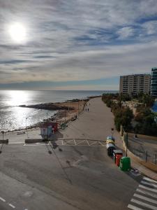 a view of a beach with a building and the ocean at NAUTILUS in Torrevieja