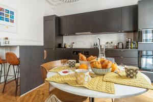 a kitchen with a table with bread on it at T2 Haussmannien renovated in Paris - Welkeys in Paris