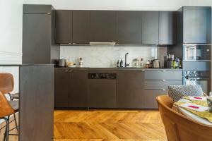 a kitchen with stainless steel appliances and a table at T2 Haussmannien renovated in Paris - Welkeys in Paris
