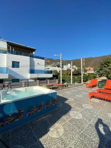 a swimming pool on the roof of a building at Hostal Acuarius in Taganga