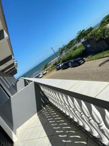 a view of the ocean from the balcony of a building at Pousada Costa do Sol in Peruíbe