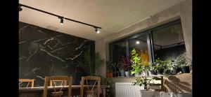 a room with a table and chairs and plants at Guesthouse Chela in Mestia