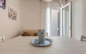 a vase sitting on top of a wooden table at La Casetta Al Mar in Porto Cesareo