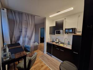 a small kitchen with a table and a dining room at Katrins-Wohntraum in Rendsburg +5 photos
