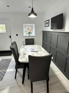 a dining room with a table and chairs at Luxury Cumbrian Cottage in Long Marton