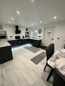 a large kitchen with a counter and a table at Luxury Cumbrian Cottage in Long Marton