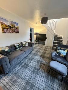 a living room with a couch and a chair at Luxury Cumbrian Cottage in Long Marton