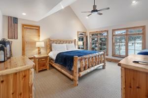 a bedroom with a wooden bed and windows at Pine Mountain Sanctuary in Edwards