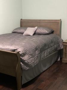 an unmade bed with a pillow and a night stand at 5821 Gowdy lane bakersfield Ca 93307 in Bakersfield