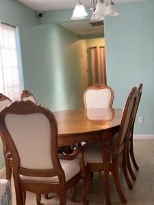 a dining room table with chairs and a mirror at 5821 Gowdy lane bakersfield Ca 93307 in Bakersfield