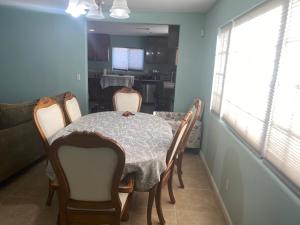 a dining room with a table and chairs and a kitchen at 5821 Gowdy lane bakersfield Ca 93307 in Bakersfield