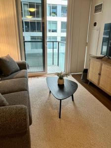 a living room with a couch and a coffee table at Cozy & charming Downtown condo! in Toronto