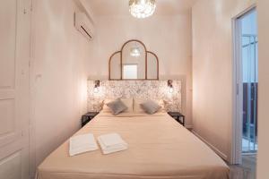 a bedroom with a large bed with two white towels at Elegant design apartment in historical city center in Catania
