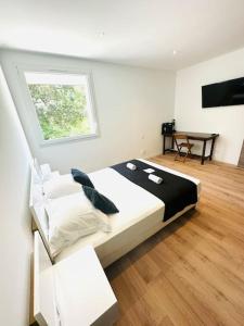 a bedroom with a large bed and a window at "T3 Les mytres " Vue mer in Kamiesch