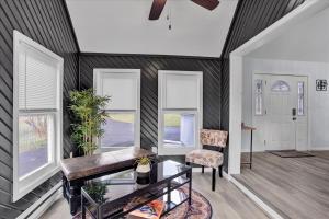 a living room with black and white striped walls and windows at Heart of Pocono Mtn 3bd 2ba Gameroom Pocono Raceway in Long Pond
