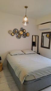 a bedroom with a bed with plates on the wall at Cosy Studio 200 m from Nice Beach & Promenade des Anglais in Nice