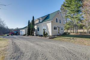 a house with a tractor parked on the side of a road at Quiet Bradford Retreat Near Hiking and Fishing! 