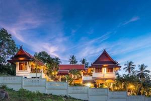 a resort with two large white buildings and palm trees at Entire 5 beds Pool Villa on hill side. in Amphoe Koksamui