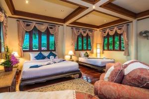 a large bedroom with two beds and a couch at Entire 5 beds Pool Villa on hill side. in Amphoe Koksamui