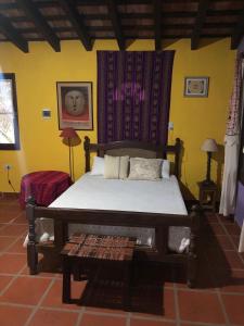 a bedroom with a bed and a table in a room at Prana Eco hospedaje in Cordoba