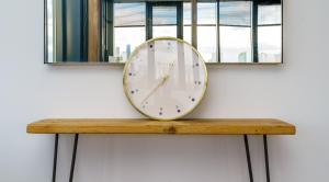 a clock sitting on top of a table on a wall at Luxury Central London Penthouse in London