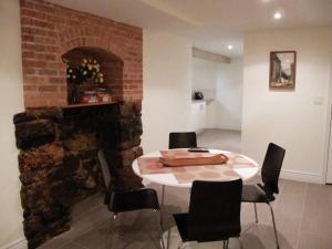 a table and chairs in a room with a brick wall at The Griffin B and B, Private two bedroom suite in Victorian Ditmas Park in Brooklyn
