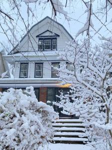 a house with snow covered trees in front of it at The Griffin B and B, Private two bedroom suite in Victorian Ditmas Park in Brooklyn