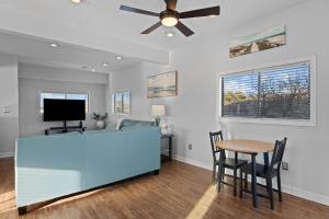 ein Wohnzimmer mit einem Deckenventilator und einem Tisch in der Unterkunft 5310 - Wright by the Beach by Resort Realty in Kill Devil Hills