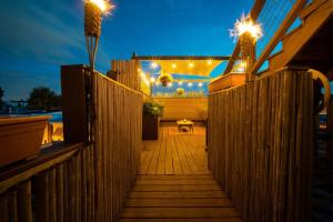 a wooden walkway with lights on the side of a house at Double Decker Roofdeck Gorgeous View in Passyunk in Philadelphia