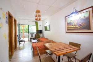 a living room with a wooden table and chairs at Hostal Acuarius in Taganga