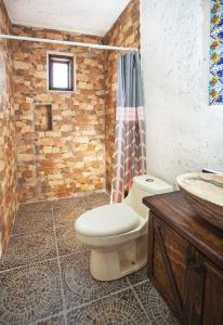 a bathroom with a toilet and a sink at Finca La Martina in Alcocer