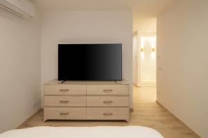 a television sitting on top of a dresser in a room at Brand new home in the center of the Old Town in Klaipėda